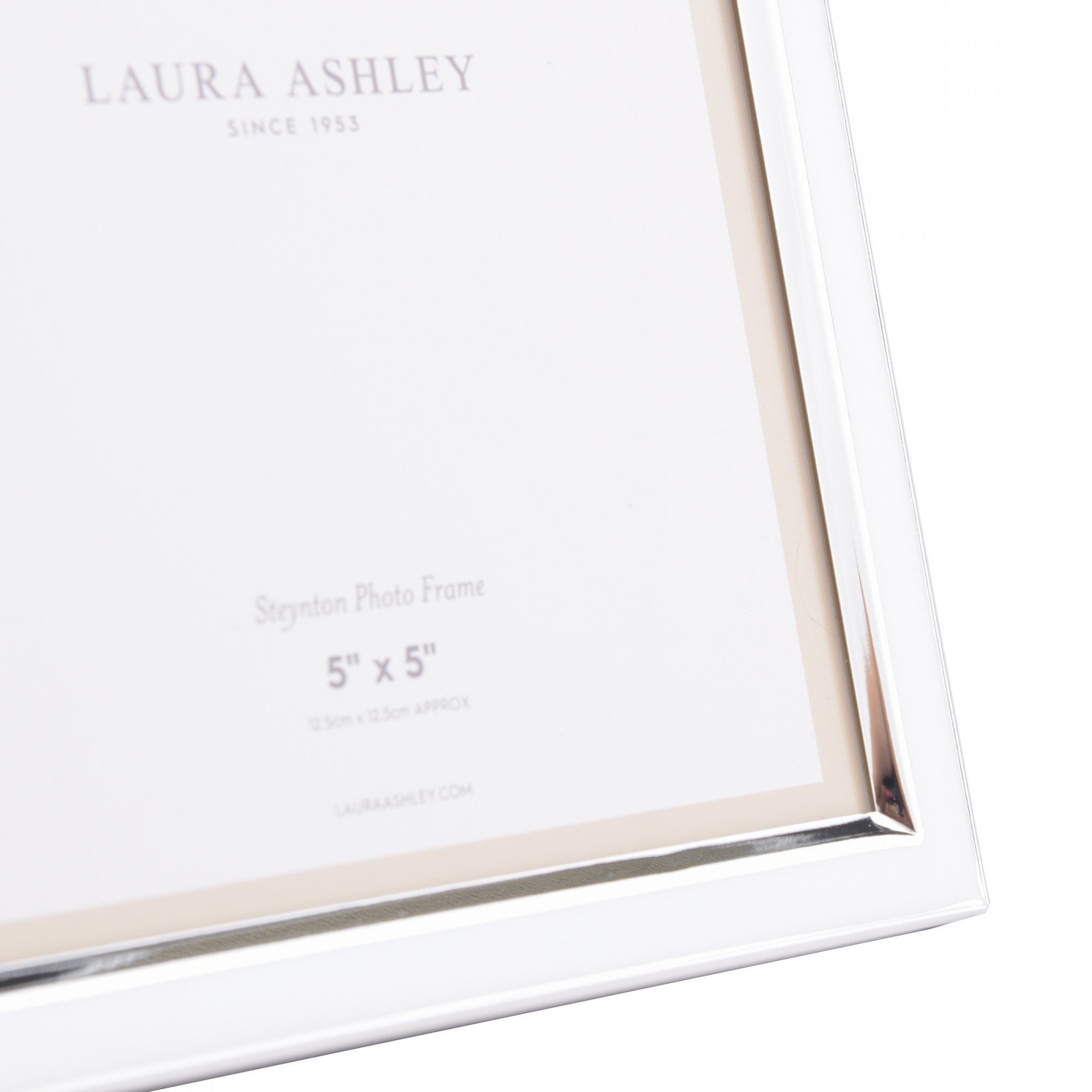 Close-up of a white Laura Ashley 5" x 5" photo frame.