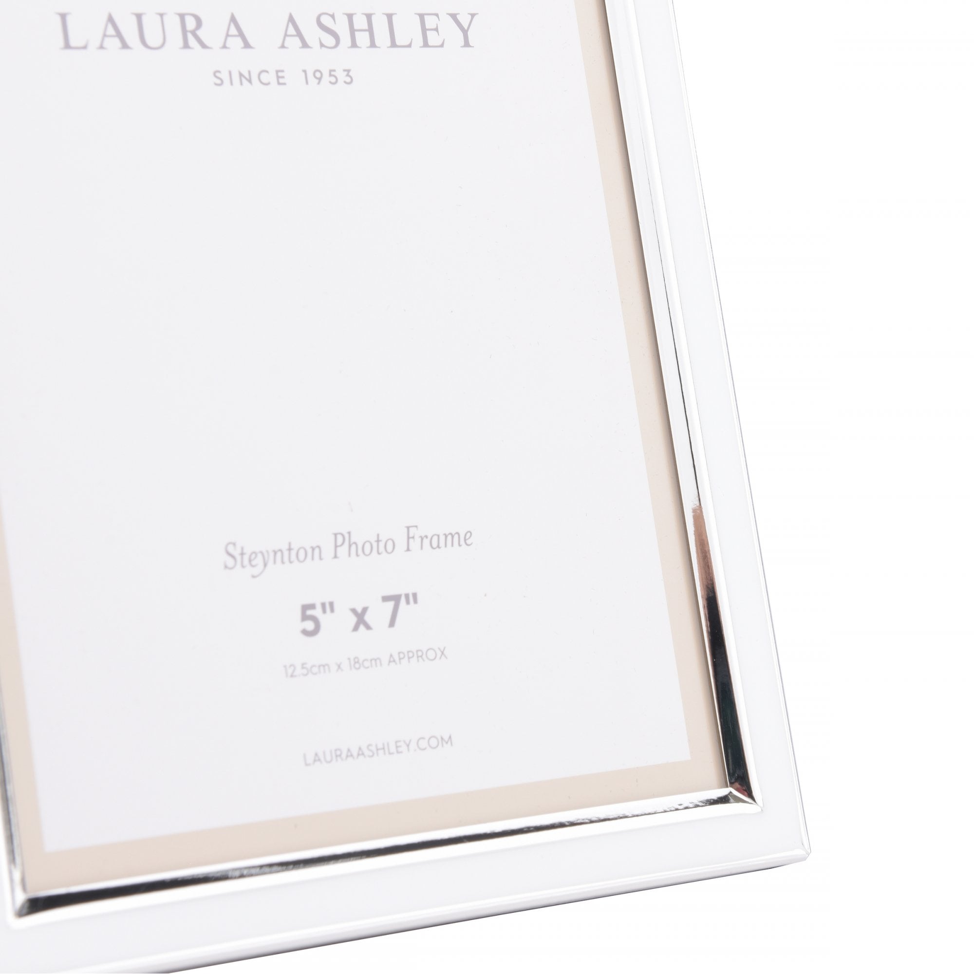 Close-up of a silver photo frame's bottom right corner, highlighting its details.