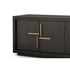 Close-up of the dark wood console's left side, showing gold criss-cross handles.