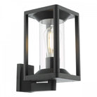 A black outdoor wall light with a clear cylindrical glass diffuser and an exposed bulb.