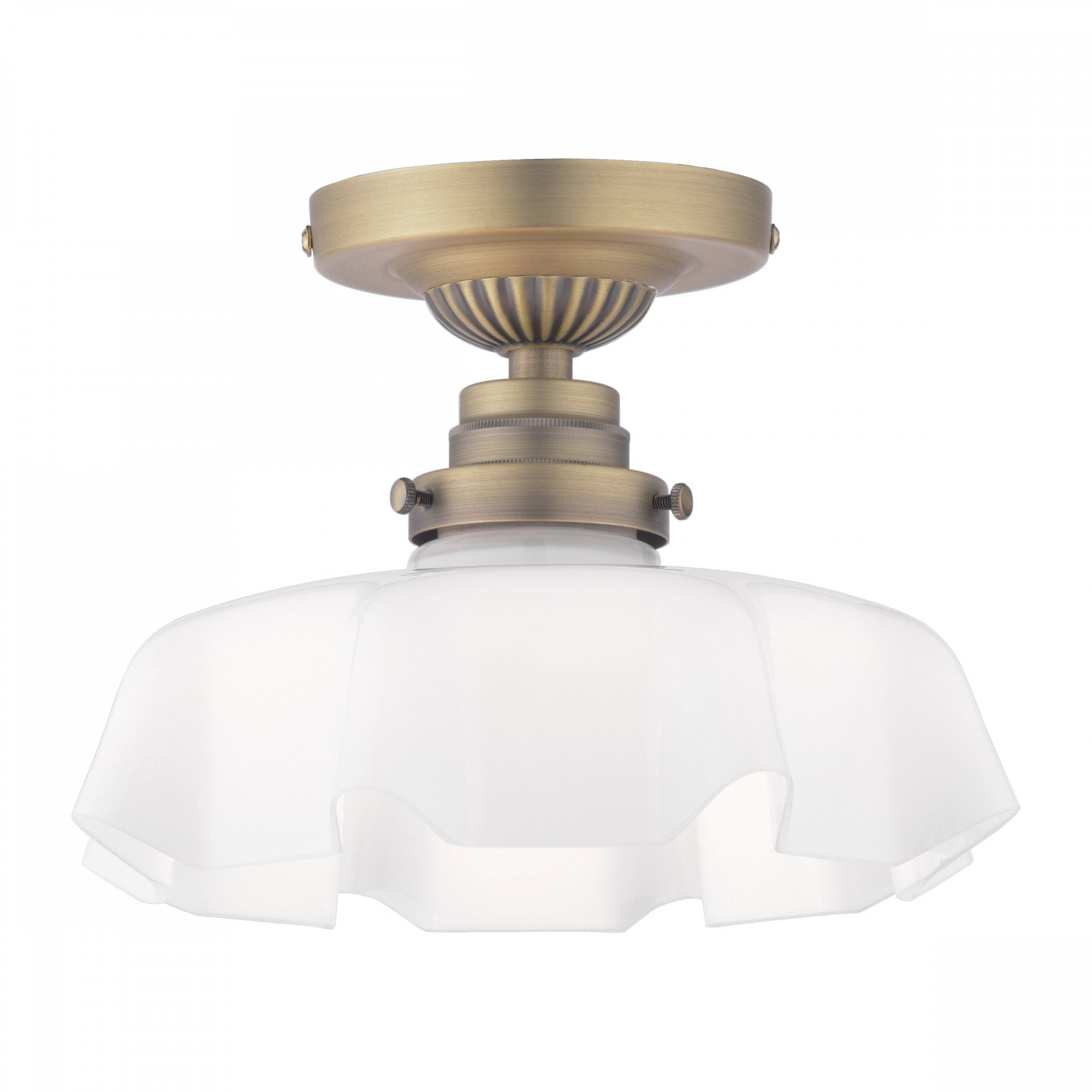 A close-up of a brass ceiling light with a ruffled, translucent glass shade and a glowing bulb.