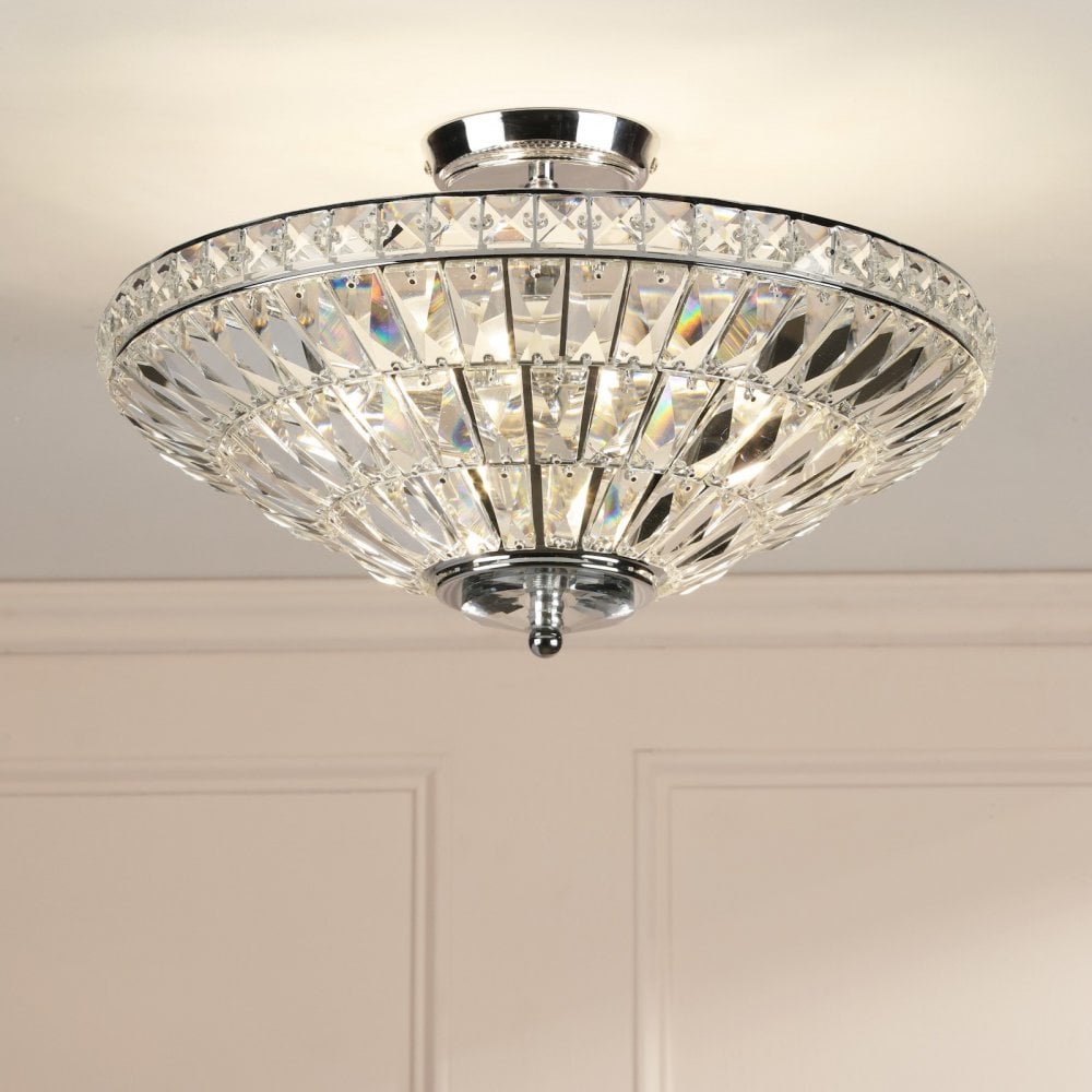 A close-up of a glamorous crystal ceiling light, featuring multiple facets that reflect light.
