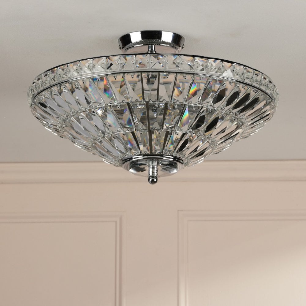 A sparkling crystal ceiling light on a white ceiling, providing a touch of elegance.