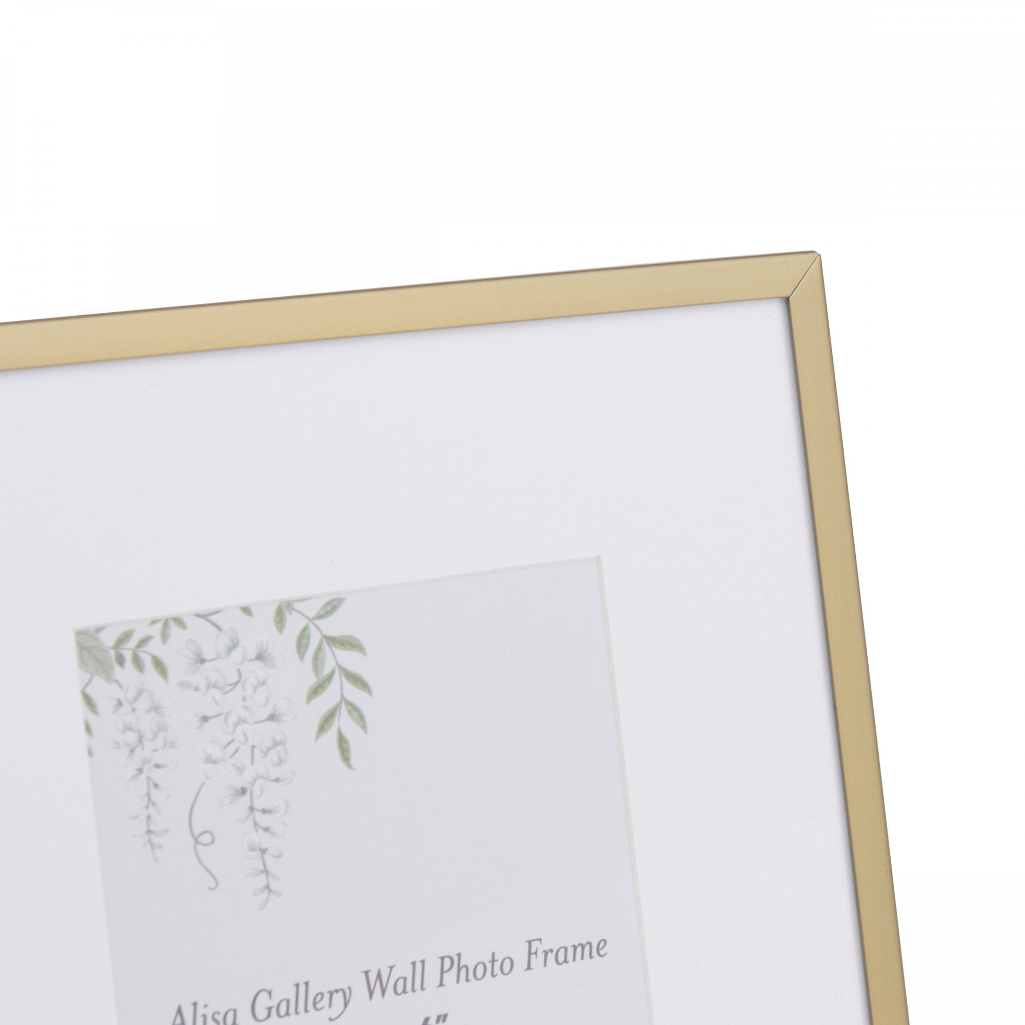 Close-up of a gold picture frame with a white mat and a floral design insert.